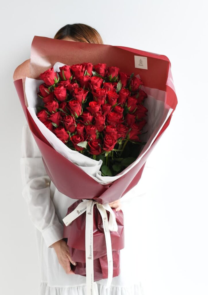 赤色のラッピングをした赤バラの花束